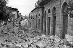 A devastated street in Argostoli showing blockage in street with fallen masonry, August 1953. Image from Imperial War Museums, A32648
