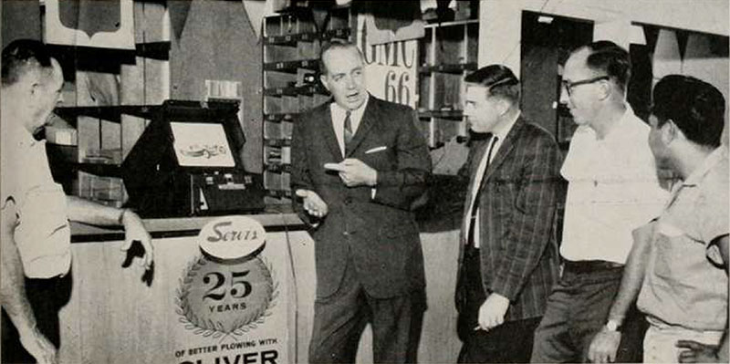 Servis executives with their Technicolor Instant Movie projector and rear-projection screen